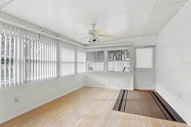 unfurnished sunroom with ceiling fan