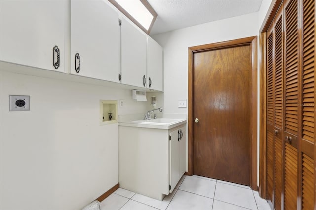 washroom featuring hookup for an electric dryer, hookup for a washing machine, cabinets, sink, and light tile patterned floors