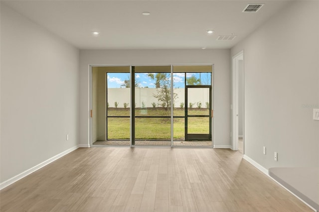 unfurnished room with light hardwood / wood-style flooring