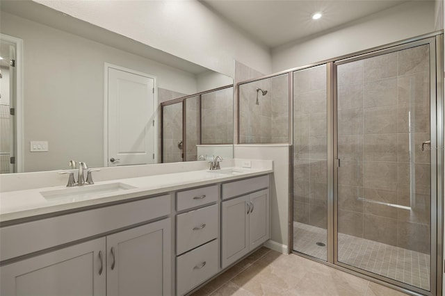 bathroom featuring tile patterned floors, vanity, and a shower with shower door