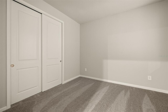 unfurnished bedroom with carpet floors and a closet