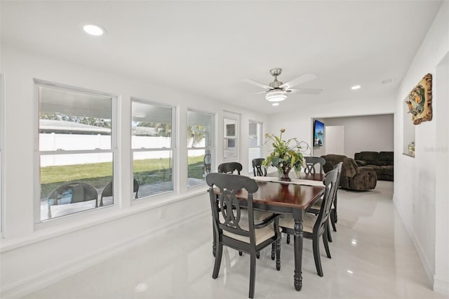 dining area with ceiling fan and light tile patterned flooring