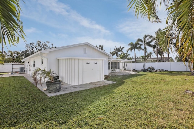 view of yard featuring a sunroom and central AC unit