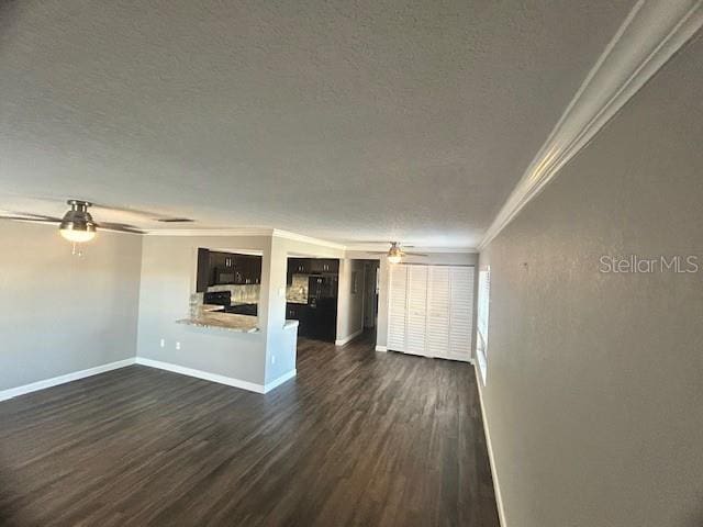 unfurnished living room with a textured ceiling, dark wood-type flooring, ceiling fan, and ornamental molding