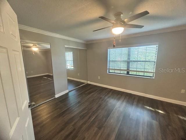 spare room with a textured ceiling, dark hardwood / wood-style flooring, ceiling fan, and ornamental molding