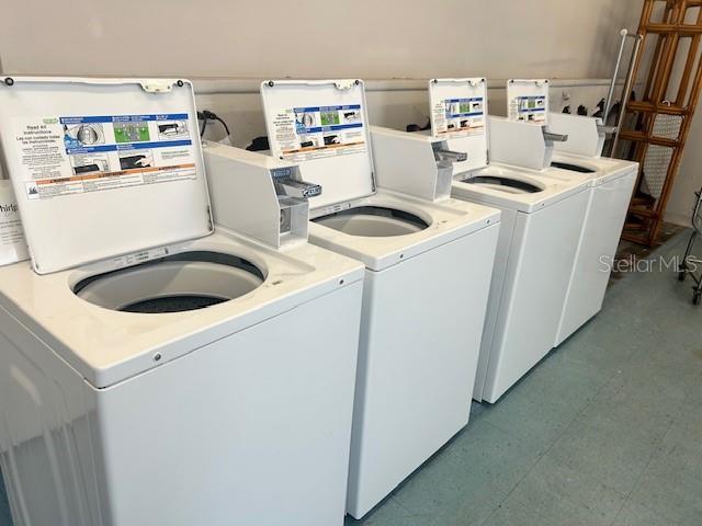 clothes washing area with washer and clothes dryer