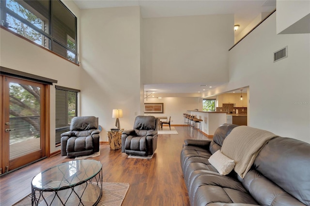 living room with a high ceiling and hardwood / wood-style flooring