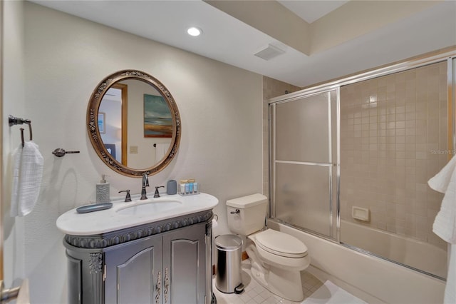 full bathroom featuring tile patterned floors, vanity, toilet, and combined bath / shower with glass door