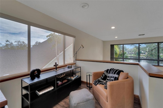 sitting room featuring hardwood / wood-style floors and a water view