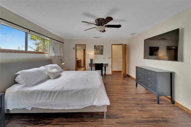 bedroom featuring ceiling fan, dark hardwood / wood-style flooring, and a textured ceiling