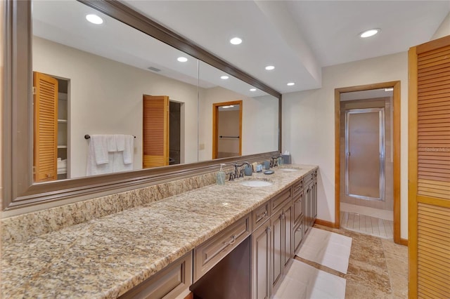 bathroom with tile patterned floors, vanity, and walk in shower