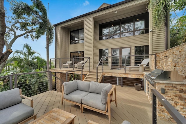 wooden deck featuring area for grilling and a grill