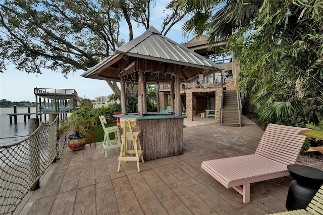 view of patio / terrace featuring a gazebo, a water view, and an outdoor bar