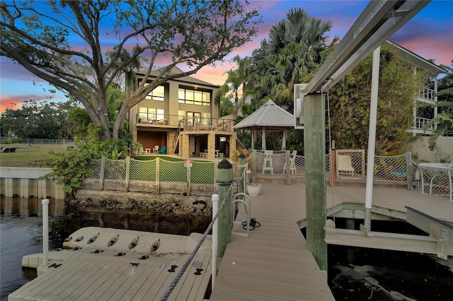 dock area with a gazebo and a wooden deck