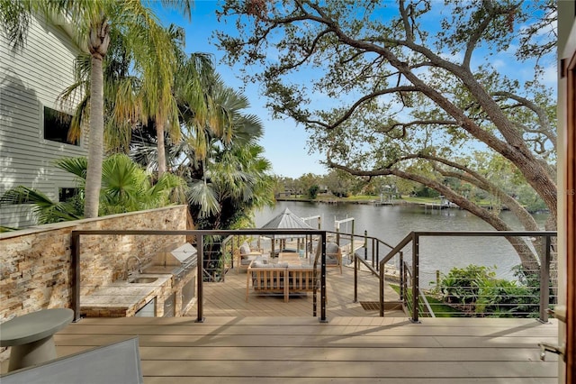 deck with a water view and sink