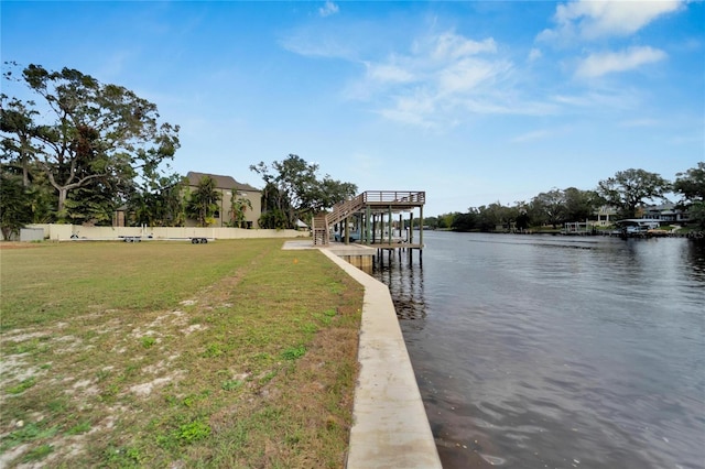 dock area with a yard and a water view