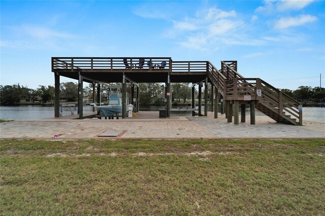 view of community featuring a water view and a yard