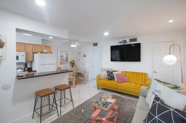 living room featuring ceiling fan and light tile patterned floors