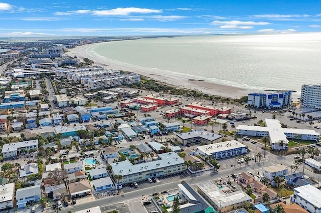 drone / aerial view featuring a water view and a view of the beach