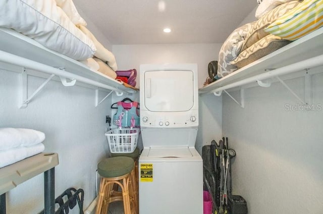 laundry area featuring stacked washer / dryer