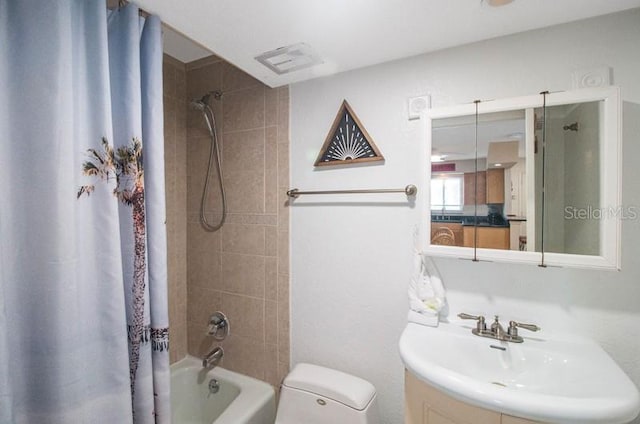 full bathroom with shower / bath combo, toilet, and vanity