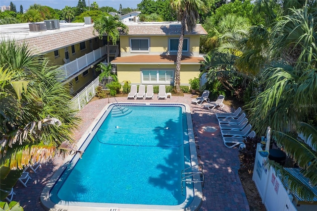 view of pool featuring central AC unit and a patio