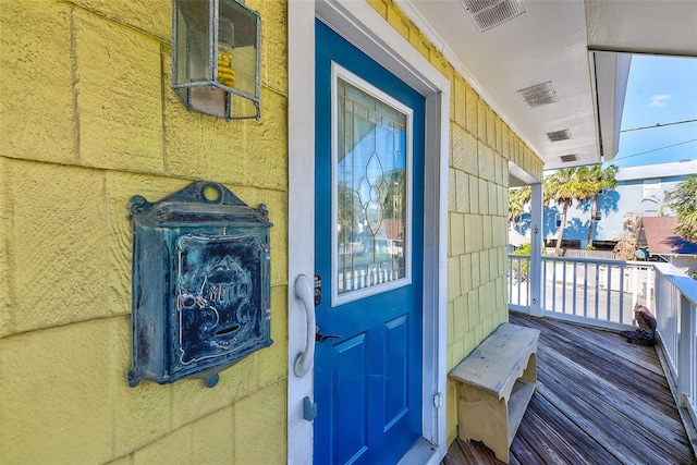 view of exterior entry with covered porch