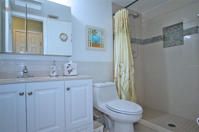 bathroom with vanity, decorative backsplash, toilet, walk in shower, and tile walls