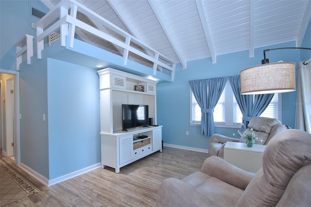 living room with beamed ceiling, light wood-type flooring, high vaulted ceiling, and wood ceiling