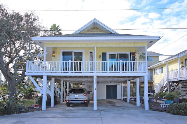 coastal inspired home with a carport and a porch