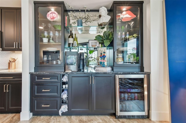 bar featuring tasteful backsplash, wine cooler, and dark stone counters