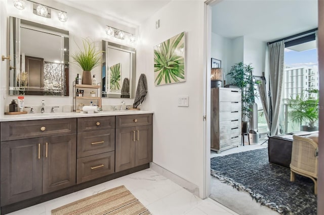 bathroom featuring vanity and floor to ceiling windows