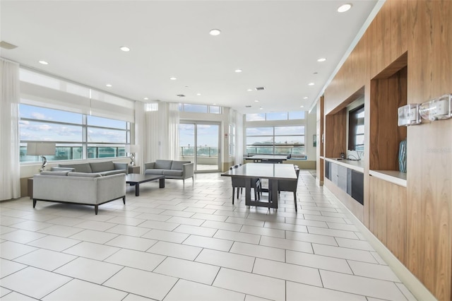 dining area featuring light tile patterned floors and wood walls