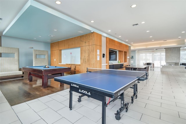 game room with billiards, light tile patterned floors, and wood walls