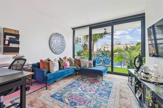 living room featuring floor to ceiling windows and ceiling fan