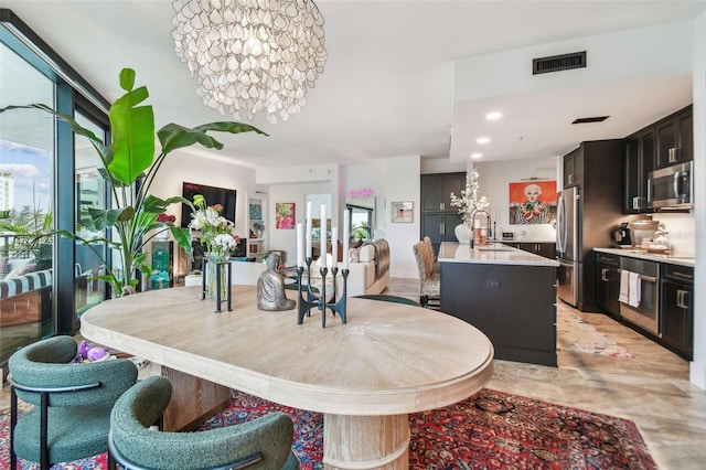 dining room with sink and a notable chandelier