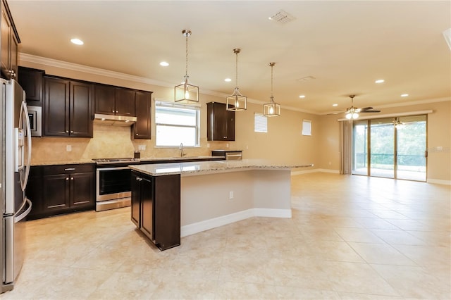 kitchen with ceiling fan, a center island, light stone counters, and appliances with stainless steel finishes