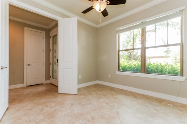 spare room featuring ceiling fan and ornamental molding