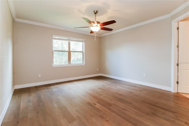 spare room with hardwood / wood-style floors, ceiling fan, and ornamental molding