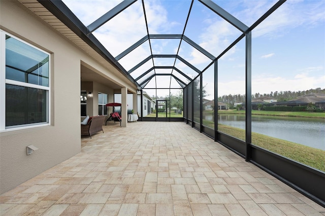 unfurnished sunroom featuring a water view