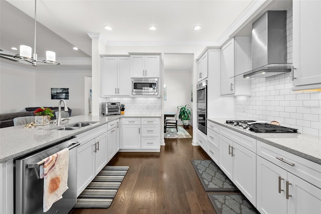 kitchen with appliances with stainless steel finishes, dark hardwood / wood-style floors, white cabinetry, and wall chimney range hood