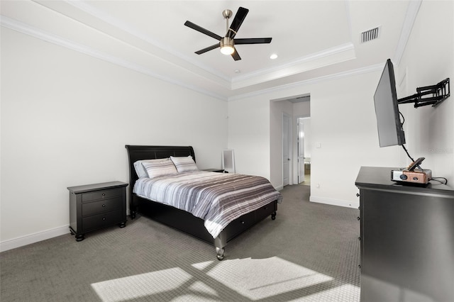 bedroom featuring a tray ceiling, ceiling fan, crown molding, and dark carpet