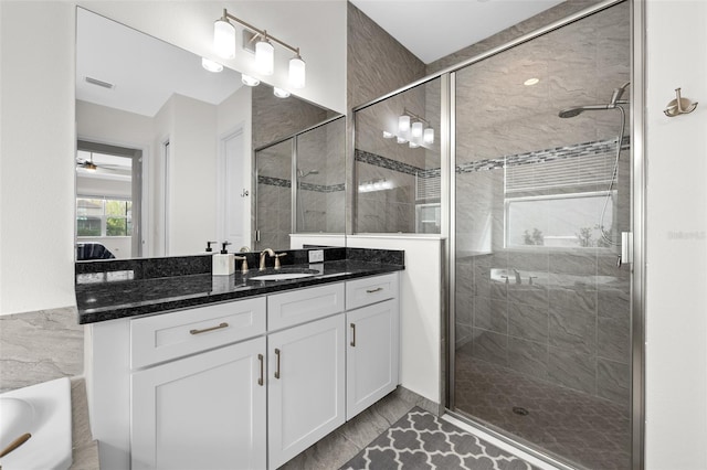 bathroom with separate shower and tub, vanity, and tile walls