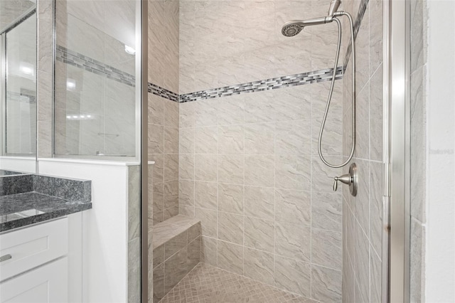 bathroom featuring vanity and a tile shower