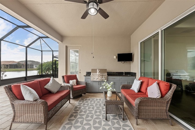 sunroom with ceiling fan, sink, and a water view