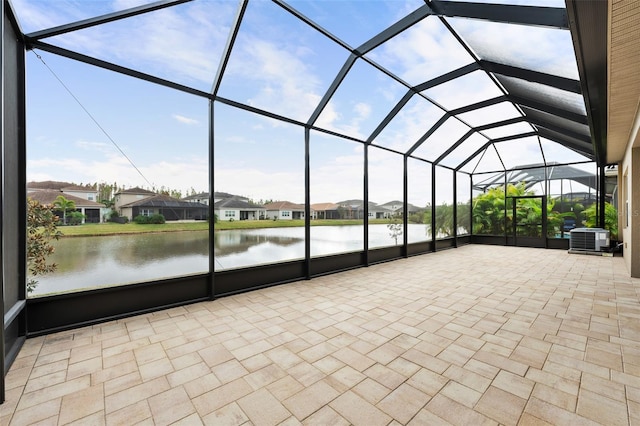 unfurnished sunroom featuring a water view