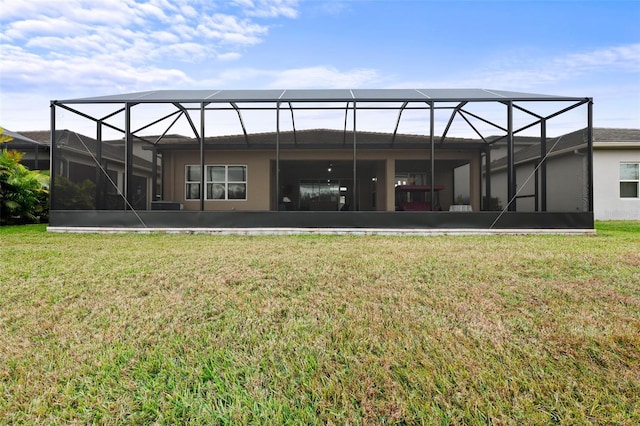 back of property with a lanai and a yard