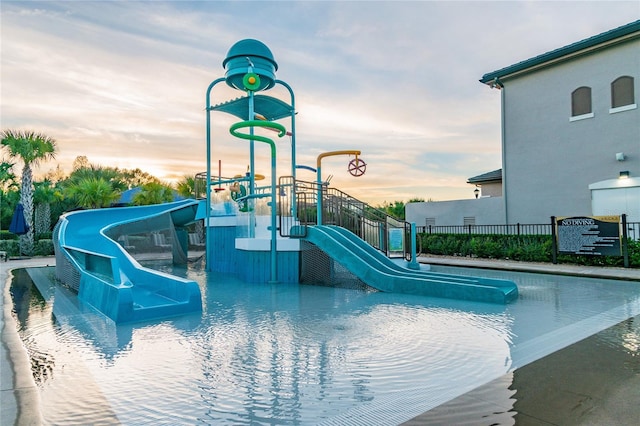 view of pool at dusk