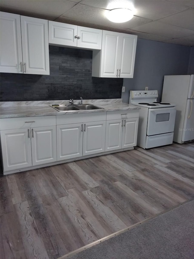 kitchen featuring tasteful backsplash, sink, white appliances, and light wood-type flooring