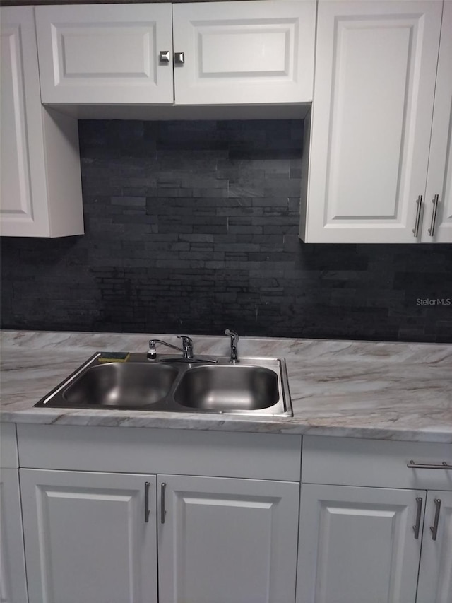 kitchen featuring white cabinetry and tasteful backsplash